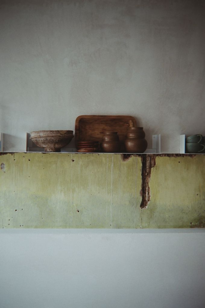 Ceramic bowls on a weathered concrete shelf