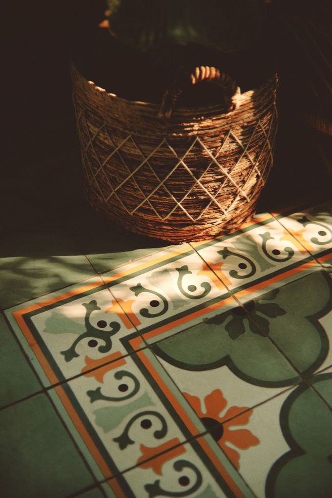 Woven basket lamp over patterned cement tiles