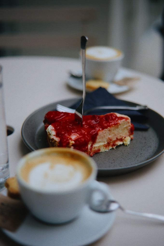 Cappuccino and a slice of strawberry cake