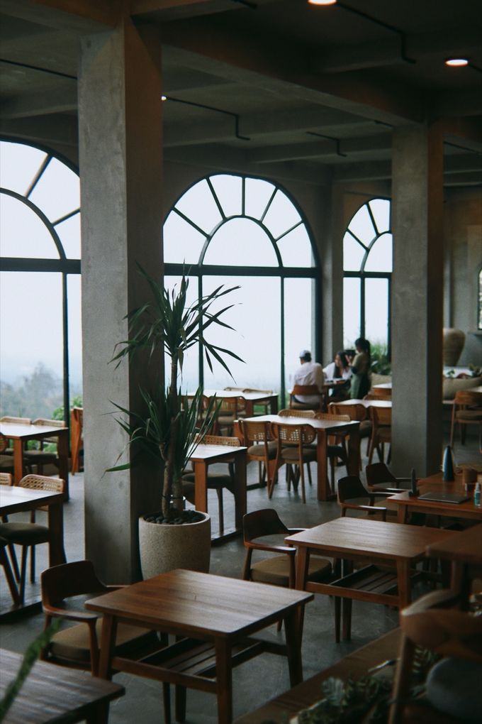 Dining hall with arched windows and concrete columns