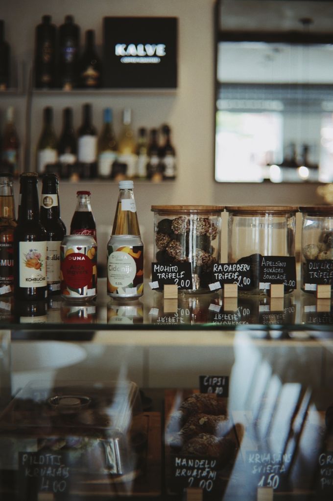Bar shelves with bottles and jars of sweets under a Kalve sign