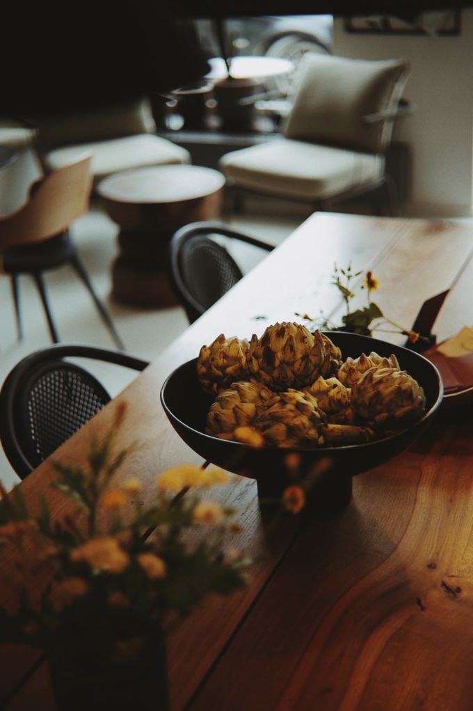 Fried artichokes in a bowl on a wooden table